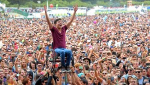 Man in wheelchair celebrates at a concert